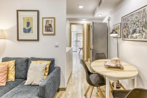 a living room with a couch and a table at La Pau de Portbou 2 in Portbou
