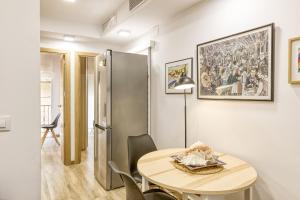 a dining room with a table and a refrigerator at La Pau de Portbou 2 in Portbou +15 photos
