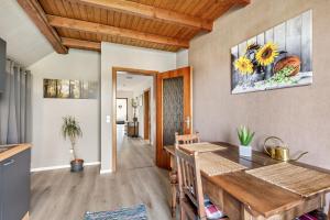 a kitchen and dining room with a wooden table at Haus Schönblick in Amorbach