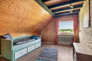 a bedroom with a bed and a window at Haus Schönblick in Amorbach