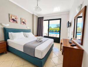 a hotel room with a bed and a desk at Ionion Apartments & Studios in Nydri