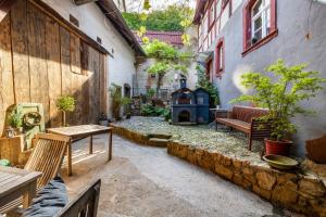 an outdoor patio with a fireplace in a building at Heimat Liebe_Scialla in Herbolzheim