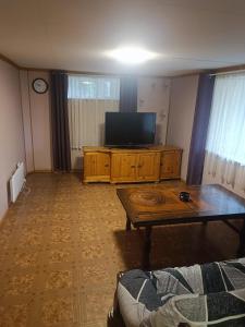 a living room with a tv and a coffee table at Aurora appartmens in Senja