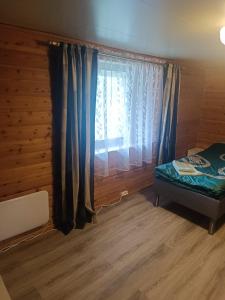 a bedroom with a bed and a window at Aurora appartmens in Senja