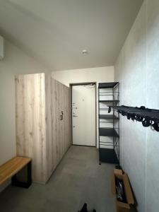 a room with a door and a room with a shelf at Koyuki Kimobetsu in Abuta