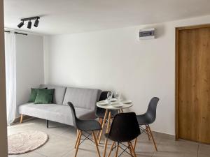 a living room with a couch and a table with chairs at Apartamenty Piotrowice in Piotrowice