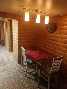 a dining room with a table and two chairs at Aurora appartmens in Senja +13 photos