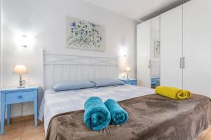 a bedroom with a bed with blue towels on it at Piccola Oasi Corralejo in Corralejo +16 photos