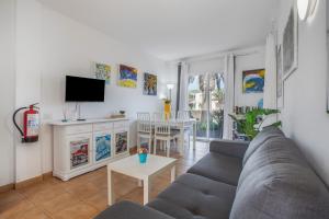 a living room with a couch and a table at Piccola Oasi Corralejo in Corralejo