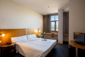 a hotel room with a bed and a flat screen tv at Hotel Porta de Gallecs in Mollet del Vallès