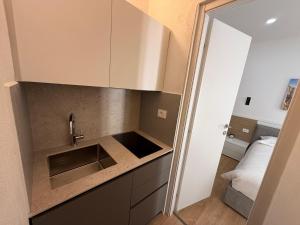 a kitchen with a sink and a counter top at Adriatic Breeze Rooms in Mola di Bari +54 photos