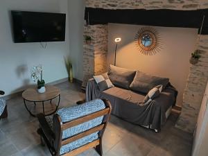 a living room with a couch and a table at Chez eugénie in Génis