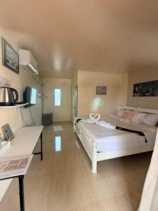 a large room with two beds and a desk at Home Hakim in Cha Am +44 photos