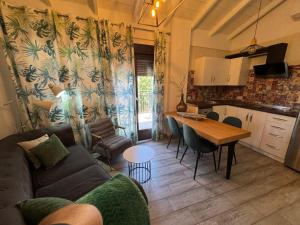 a living room and kitchen with a couch and a table at Casa del Agua in Cazorla