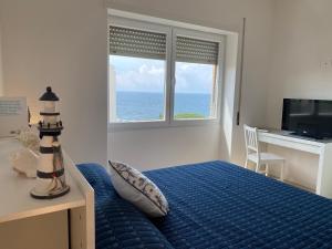 a bedroom with a bed and a desk and a window at Il Piccolo Cristallo sul Mare in Santa Marinella +10 photos