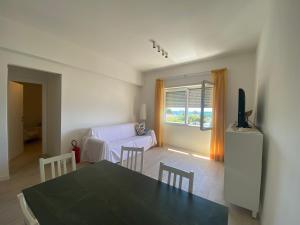 a living room with a table and a couch at Il Piccolo Cristallo sul Mare in Santa Marinella