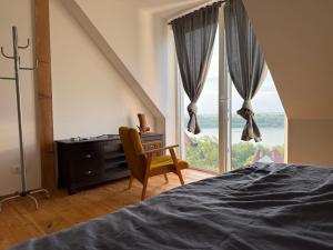 a bedroom with a desk and a bed and a window at Danube House in Mohács +10 photos