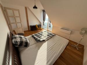 a bedroom with a large white bed with two pillows at Danube House in Mohács