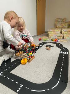 two young children playing with a toy track at Playroom, 2 bdrooms, KRUMLOV 5 min by car, "Stone's throw Apartment" in Kájov