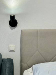 a lamp on a wall next to a bed at Salt & Sea in Sarti