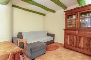 a living room with a couch and a wooden cabinet at Amour de Provence in Nyons