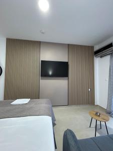 a hotel room with a bed and a couch at Salt & Sea in Sarti