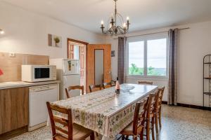 a kitchen and dining room with a table and chairs at Gîte La Motette Drôme Provençale in Rousset-les-Vignes