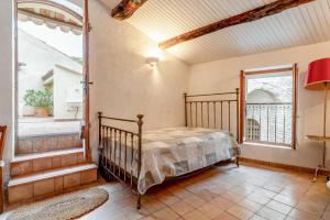 a bedroom with a bed and a window at Amour de Provence in Nyons