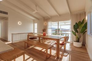 a dining room with a table and chairs at Casa Airlie in Airlie Beach