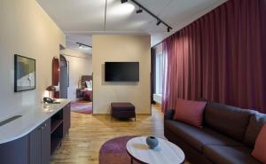 a living room with a couch and a table at Scandic Kiruna in Kiruna
