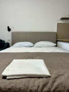 a bed with two white towels on top of it at Salt & Sea in Sarti