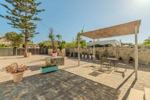 a patio with a table and chairs and a pavilion at Aspasia House in Platanias