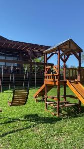 two swings and a bench in a park at Cabañas Boutique Pipi Cucu in Colón