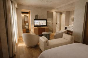 a hotel room with a bed and a television at Porto Antico in Chania