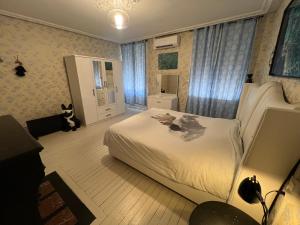 a bedroom with a white bed and a mirror at Chambre bleue in Vigneulles-lès-Hattonchâtel