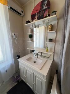 a bathroom with a sink and a mirror at Chambre bleue in Vigneulles-lès-Hattonchâtel +6 photos