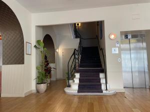 a hallway with a spiral staircase in a building at Hôtel De Paris in Sète