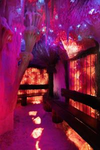 a room with pink and purple lights and benches at Hotel nad morzem - Art-Pension - Dąbrowa - Holiday & SPA in Świerzno +43 photos