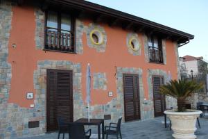 a building with tables and chairs in front of it at The Chalet, guest house in Agerola