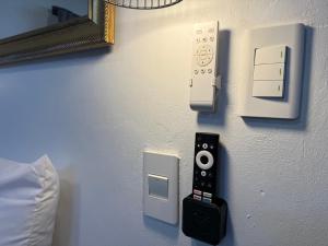 a remote control and an ipod on a wall at 16 st Johns - Studio 2 in Port Shepstone
