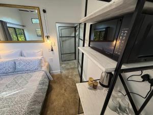 a small room with a bed and a tv at 16 st Johns - Studio 2 in Port Shepstone