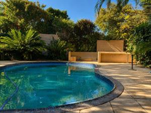 a small swimming pool in a yard with trees at 16 st Johns - Studio 2 in Port Shepstone