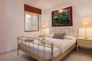 a bedroom with a bed and a painting on the wall at Lets Holidays INCREDIBLE APARTMENT WITH AMAZING VIEWS in Tossa de Mar