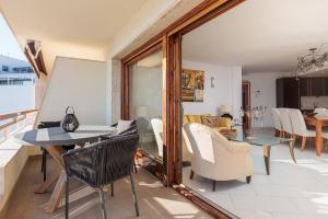 a living room with a table and chairs at Lets Holidays INCREDIBLE APARTMENT WITH AMAZING VIEWS in Tossa de Mar