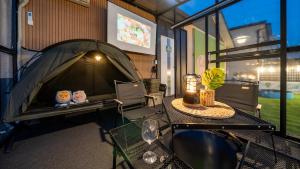 a tent with a table with a lamp and a table sidx sidx sidx at Gapyeong Dangdangi Pet Pension Green in Gapyeong