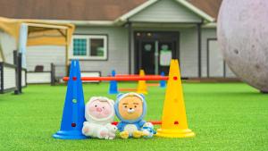 two stuffed animals sitting next to cones on a playground at Gapyeong Dangdangi Pet Pension Green in Gapyeong