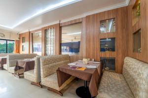 a dining room with a table and chairs at Margao Residency in Madgaon
