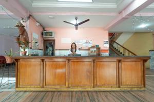 a woman standing behind a bar in a building at Margao Residency in Madgaon