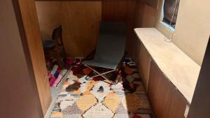 a chair sitting in a room with a rug at MAGATAMA.INN in Sumoto
