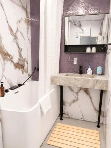 a bathroom with a tub and a sink and a mirror at Zao Sunvalley Hotel in Yamagata +23 photos